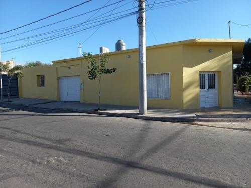żółty budynek po stronie ulicy w obiekcie MARGARITA ALOJAMIENTO TEMPORARIO w mieście San Fernando del Valle de Catamarca