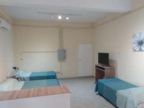 Pokój szpitalny z dwoma łóżkami i telewizorem w obiekcie MARGARITA ALOJAMIENTO TEMPORARIO w mieście San Fernando del Valle de Catamarca