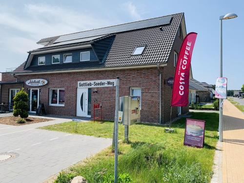 a brick building with a sign in front of it at Gäste und Messezimmer Adelheidsdorf in Adelheidsdorf