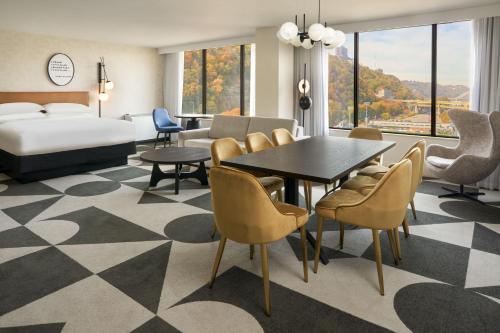 a hotel room with a bed and a table and chairs at Sheraton Pittsburgh Hotel at Station Square in Pittsburgh