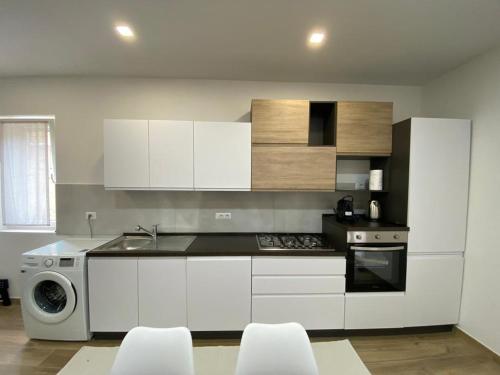 瓦雷多利亞的住宿－Le Pavoncelle，厨房配有白色橱柜、洗衣机和烘干机