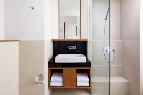 a bathroom with a sink and a shower at Fairfield by Marriott Bali Kuta Sunset Road in Kuta