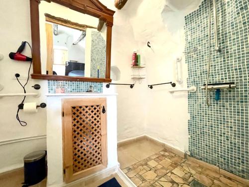 a bathroom with a shower with a glass door at Cave House in Cúllar near Tabernas Desert in Margen de Abajo