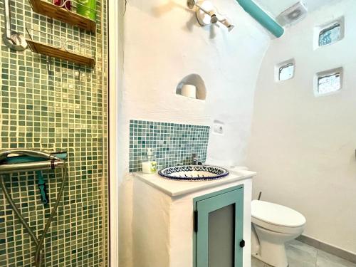 a bathroom with a sink and a toilet at Cave House in Cúllar near Tabernas Desert in Margen de Abajo