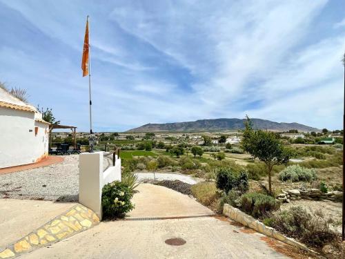 a flag on top of a building with a walkway at Cave House in Cúllar near Tabernas Desert in Margen de Abajo