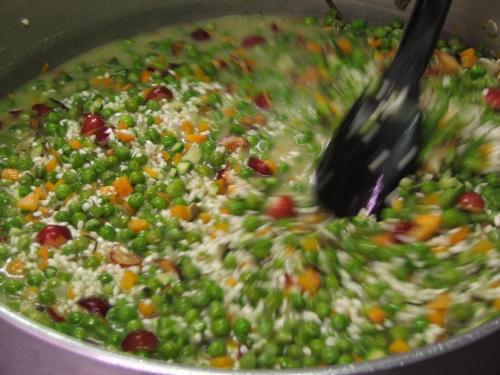 a pot of peas and rice with a spoon in it at Palazzetto Ardi in Torri di Confine