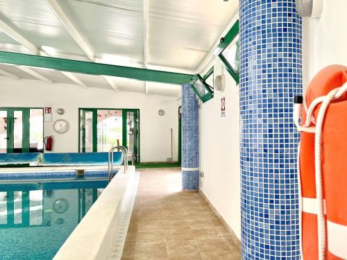 a swimming pool with blue tiles on the walls at Cave House in Cúllar near Tabernas Desert in Margen de Abajo