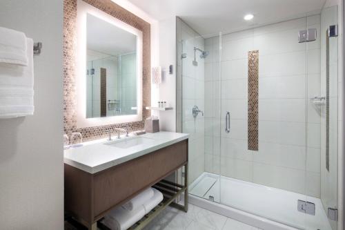 a bathroom with a sink and a shower at Sheraton Redding Hotel at the Sundial Bridge in Redding