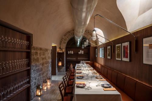 a long dining room with a long table and chairs at The Jaffa - Fattal Limited Edition in Tel Aviv