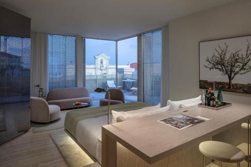 a bedroom with a bed and a room with a view at The Jaffa - Fattal Limited Edition in Tel Aviv