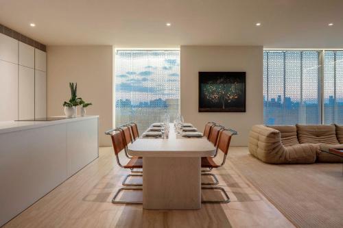 a kitchen and living room with a table and chairs at The Jaffa - Fattal Limited Edition in Tel Aviv