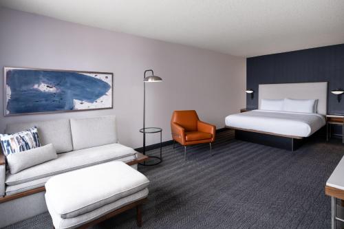 pokój hotelowy z kanapą i łóżkiem w obiekcie Courtyard by Marriott Boulder Broomfield w mieście Louisville