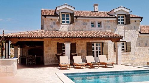 a villa with a swimming pool and a house at NEW 2023 Villa Tree of Life in Sveti Petar