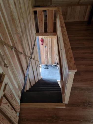 a staircase in a wooden house with a room at Domki nad Sanem in Lesko