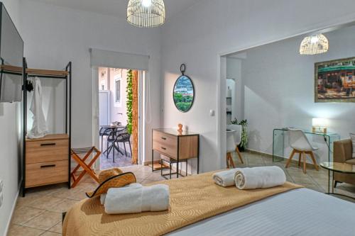 a bedroom with two beds and a dining room at Hope apt - 5min to Falassarna Bch in Kissamos