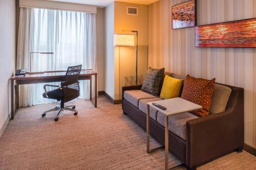 a living room with a couch and a desk at Residence Inn by Marriott Seattle University District in Seattle