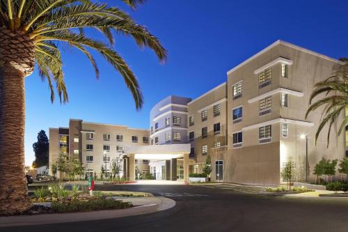 a building with a palm tree in front of it at Courtyard by Marriott Sunnyvale Mountain View in Sunnyvale