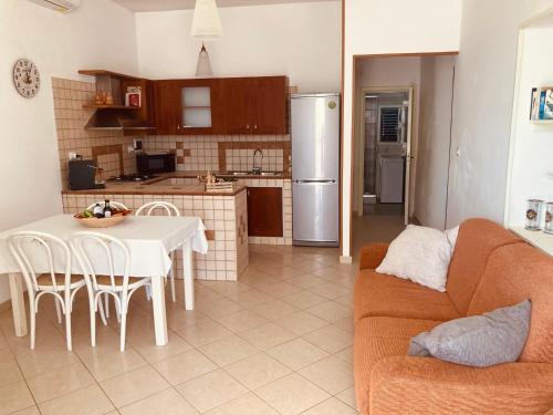 a kitchen and living room with a couch and a table at La Racioppola in Ostuni