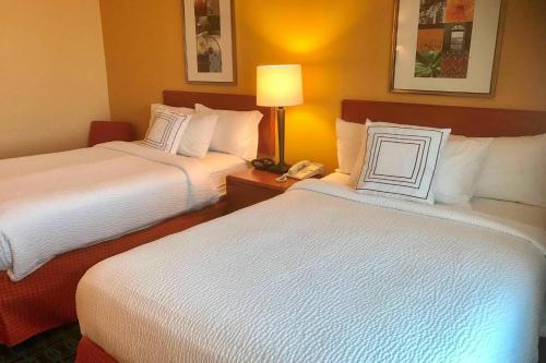 a hotel room with two beds and a phone at Fairfield Inn and Suites Sacramento Airport Natomas in Sacramento