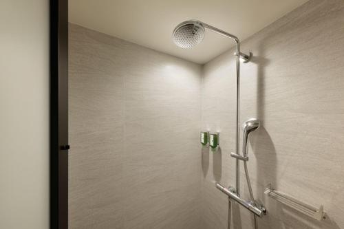 a shower with a glass door in a bathroom at Fairfield by Marriott Wakayama Kumano Kodo Susami in Susami