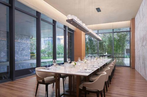 a long dining room with a long table and chairs at Yancheng Marriott Hotel in Yancheng