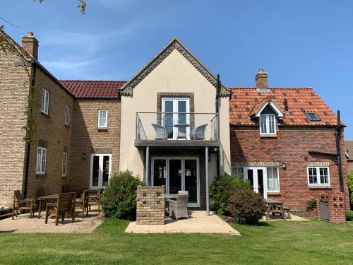 a house with a balcony on the front of it at Prospect Cottage, The Bay, balcony, 2 bedrooms, patio, parking nearby, 2 dogs welcome in Filey