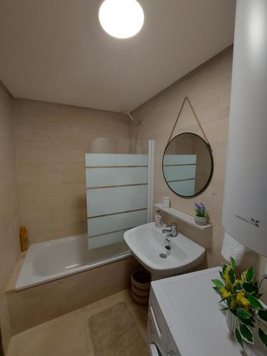 a bathroom with a sink and a tub and a mirror at La Cabaña in Vigo