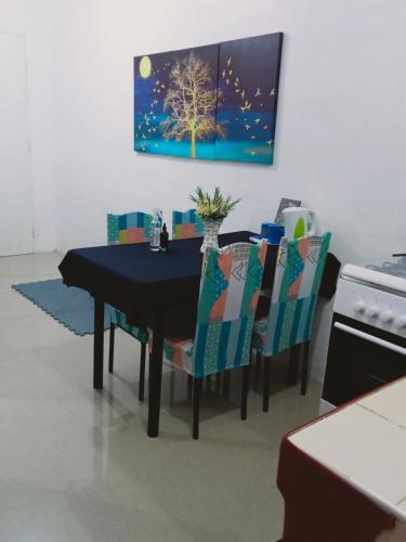 a dining room with a black table and chairs at Transient with bedroom near Padre Pio Church in San Felix