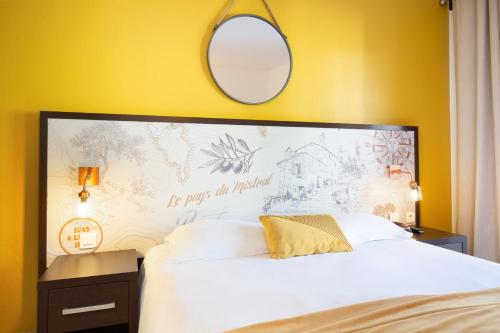 a bedroom with a large white bed with a mirror at Les Pins Blancs en Provence in Le Muy