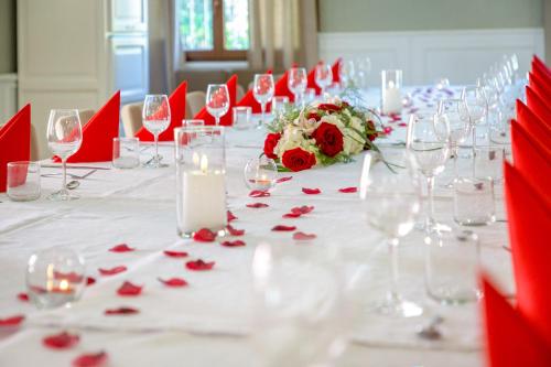 a long table with wine glasses and flowers and candles at Les Pins Blancs en Provence in Le Muy