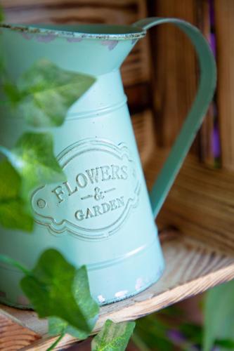 a blue vase sitting on a shelf with a plant at Les Pins Blancs en Provence in Le Muy