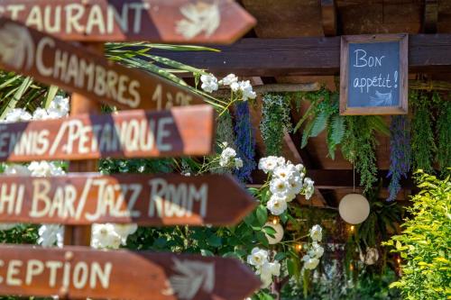 a bunch of street signs on a wall at Les Pins Blancs en Provence in Le Muy