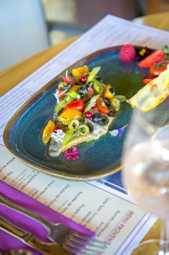 a plate of food with vegetables on a table at Les Pins Blancs en Provence in Le Muy