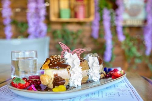 a plate of food with a dessert on a table at Les Pins Blancs en Provence in Le Muy