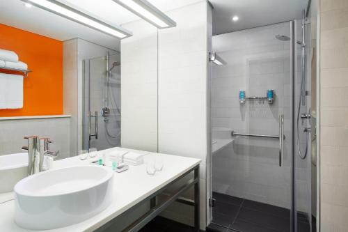 a bathroom with a sink and a shower at Aloft Dhahran Hotel in Al Khobar