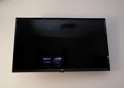 a flat screen tv hanging on a wall at ATHANASIA APARTMENTS in Skiathos Town