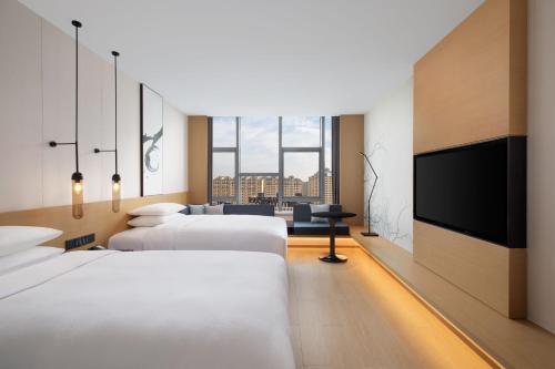 Ένα ή περισσότερα κρεβάτια σε δωμάτιο στο Fairfield by Marriott Liaocheng Dongchangfu