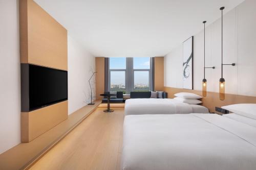 Ένα ή περισσότερα κρεβάτια σε δωμάτιο στο Fairfield by Marriott Liaocheng Dongchangfu