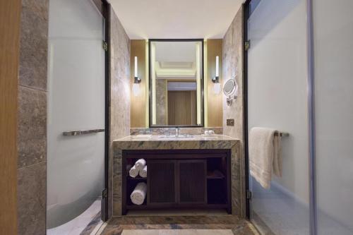 a bathroom with a sink and a mirror at The Westin Qingdao - Instagrammable in Qingdao