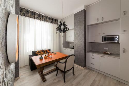 a kitchen with a table and a dining room at Avers House in Narva