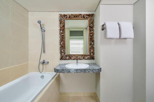 a bathroom with a sink and a mirror at Four Points by Sheraton Bali, Kuta in Kuta