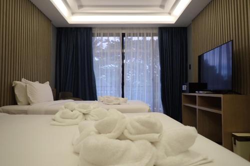 Un ou plusieurs lits dans un hébergement de l'établissement Only Seed Resort 欧芮希度假酒店