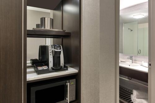 a bathroom with a coffee maker and a sink at Fairfield Inn & Suites by Marriott Boston Waltham in Waltham