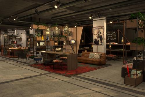 a furniture store with tables and chairs in a room at Moxy Lille City in Lille