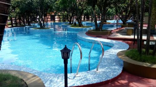 a swimming pool with blue water and a street light at CHARULATA RESIDENCY in Bolpur
