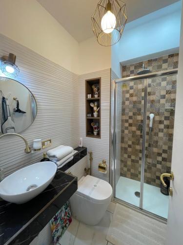 a bathroom with a toilet and a sink and a shower at Oliveri - camera con ingresso Indipendente in Oliveri