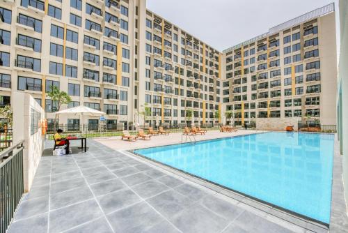 an image of the pool at the apartment building at Sleek Studio at UNA Town Square Dubailand by Deluxe Holiday Homes in Dubai