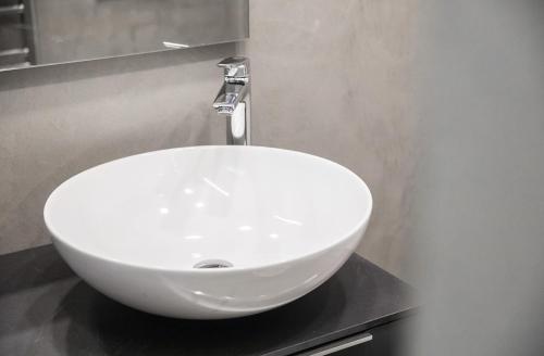 a white sink sitting on a black counter in a bathroom at Ca Bussun in Domodossola