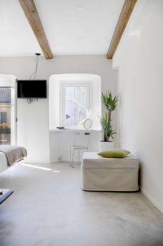 a white living room with a couch and a table at Ca Bussun in Domodossola