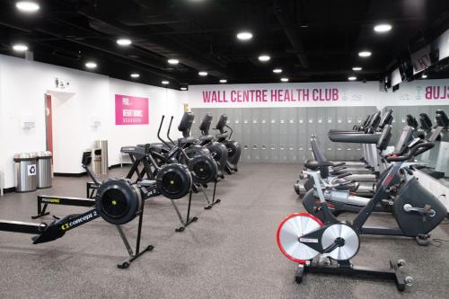 a gym with a bunch of exercise equipment in a room at Sheraton Vancouver Wall Centre in Vancouver